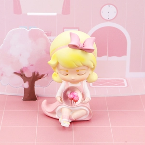 Detail of cute pink girl figurine holding a floral crystal ball night light ornament