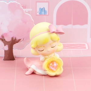 Close-up of a cute cartoon girl lamp figure with pink dress and glowing flower detail