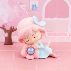 Detailed close-up of a cute sleeping girl figurine with a holographic crystal ball light