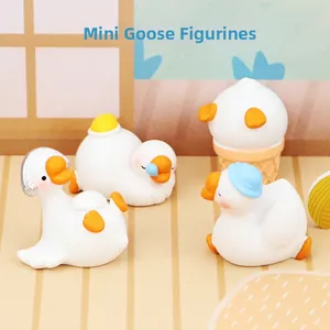 Miniature white goose figurines in four poses including headphone and ice cream styles