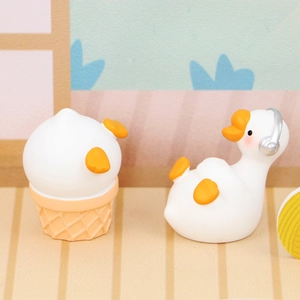 Miniature resin goose figurines featuring ice cream cone and headphones detail for desk decor