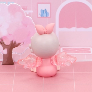 Vue arrière de figurine ange rose pour gâteau avec ailes translucides et un nœud