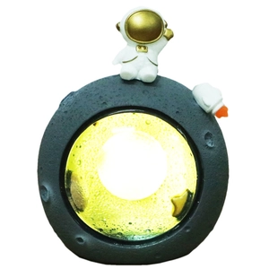 Creative astronaut moonlight night light with moon crater texture and warm glow