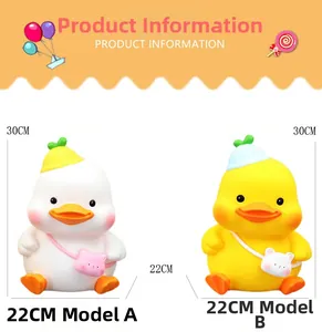 Detail of white and yellow duck piggy bank models with height 30cm and width 22cm