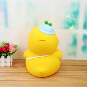 Large yellow MOMO duck piggy bank with light blue hat and coin slot on back view