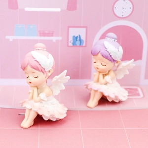 Detail of resin ballet girl figures with feather headpiece and lace skirt for car decor