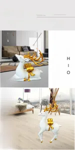 Detailed view of modern matte white and gold elk sculptures in a luxury home setting