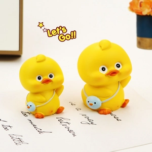 Close-up of cute yellow duck car ornaments with crossbody bags and matte finish detail