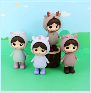 Set of four cute girl dolls in animal ponchos including cat unicorn reindeer bear figurines