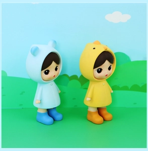 Detail of cute doll figurines in blue and yellow chicken raincoats on a cartoon background
