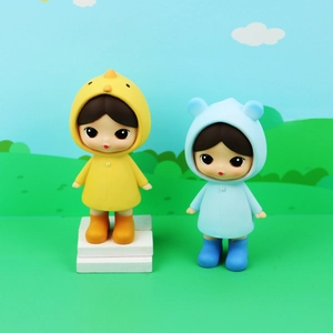 Cute collectible raincoat girl figures in yellow chick and blue bear hooded outfits