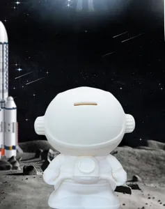 Close-up of the coin slot on a white astronaut piggy bank with a space-themed background