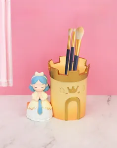 Detail of resin princess castle makeup brush holder with hand-painted gold and blue accents