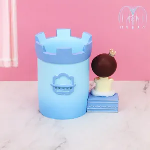 Detail of blue castle pen holder with a small crowned figure on marble base