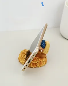 Resin phone stand with Girl with a Pearl Earring and sunflower base holding a smartphone