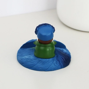 Close-up of Van Gogh art figure phone stand with Starry Night style relief patterns