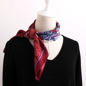 Elegant floral satin silk square scarf with vintage red patterns on a black V-neck sweater
