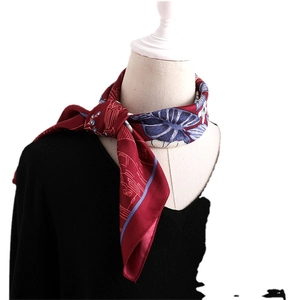 Elegant burgundy silk square scarf with blue floral patterns on a white mannequin