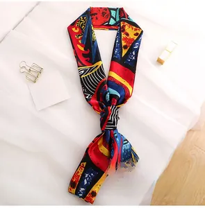 Detail of artistic long silk scarf with abstract colorful prints and modern fringe tassels