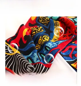 Detailed macro view of soft silk-like fabric with colorful abstract geometric patterns