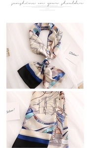Detail of nautical print silk scarf featuring anchors, rope, and elegant navy sailboats
