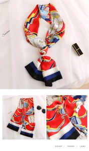 Detail of nautical print silk scarf with anchors and tassels on a white fabric backdrop