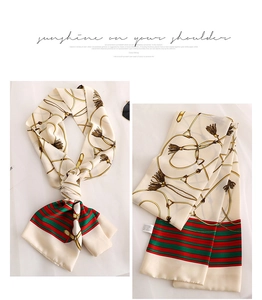 Detail of cream silk scarf with gold chain print, fringe patterns and striped edge