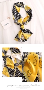 Detail of silk-like skinny scarf showing houndstooth print and geometric dot pattern