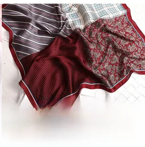 Detail of silk scarf with houndstooth and paisley pattern showing fine stitching edge