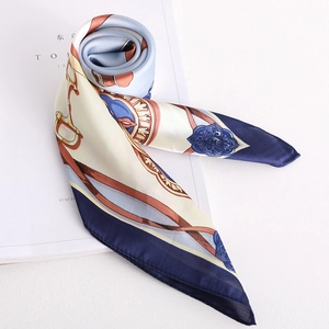 Detailed view of silk-textured square scarf featuring equestrian patterns and glossy finish