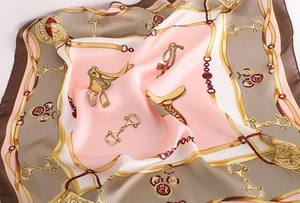 Detail of silk scarf showing vintage equestrian horse bit patterns and soft draped texture