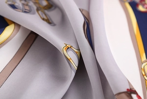 Detail of silk scarf showing vintage chain horse harness pattern and smooth texture