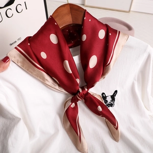 Dark red silk scarf with white polka dots on a white t-shirt and wooden hanger