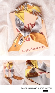Detail of silk hair band scarf featuring abstract floral and equestrian chain patterns
