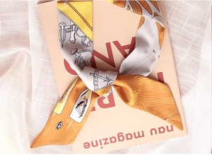 Detailed close-up of a nautical print skinny scarf tied in a bow on a mesh fabric background