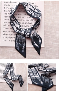 Detail of zebra pattern twilly scarf with smooth silk texture on pink background