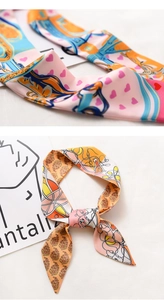 Detail of floral and heart print silk twilly scarves with elegant equestrian patterns