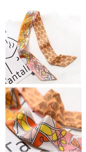 Macro texture of orange and yellow scarf showing abstract chain and paisley patterns