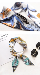 Macro detail of twilly scarf featuring floral prints and fine twill texture