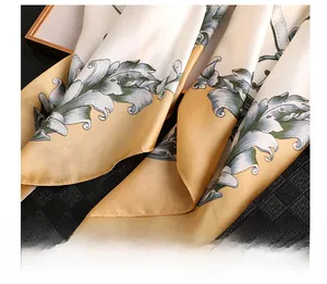 Detail showing elegant leaf patterns and fine stitching on high-quality satin scarf