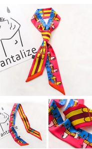 Detail of a long narrow scarf with vintage horse print and geometric stripes in pink and blue