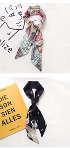 Detail of satin twilly scarves with floral bird and swan prints on a textured fabric