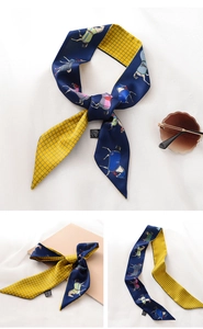 Detail of horse print twilly scarf featuring navy blue pattern and yellow checkered lining