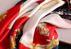 Detail of silk-like scarf with baroque gold patterns and red-blue color blocking