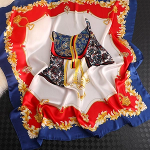 Detailed view of large red and blue silk scarf with baroque gold patterns and saddle design