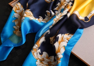 Close-up of silk scarf showing baroque patterns and soft satin fabric texture