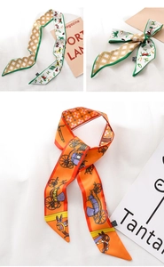 Detail of luxury satin scarves with equestrian horse prints and vintage carriage patterns