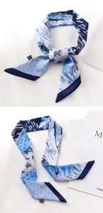 Detail of blue twilly scarf showing equestrian horseshoe print and feather textures