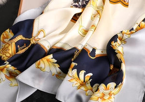 Close-up of printed silk-like scarf with classic Baroque chain and strap buckle patterns