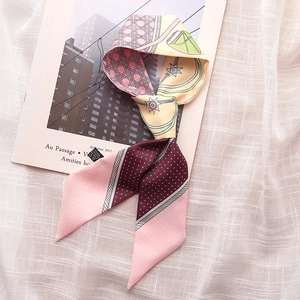 Elegant floral and polka dot skinny scarf on magazine, stylish spring accessory